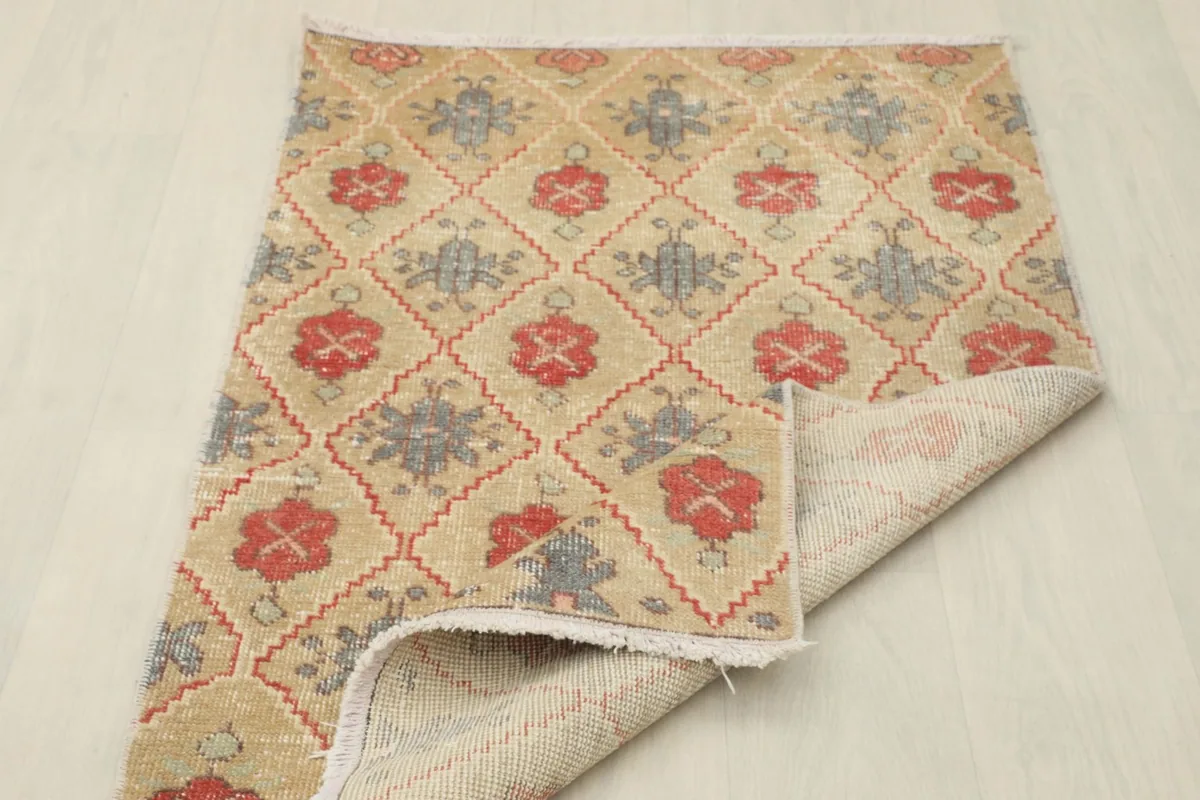 The rug partially folded, showing the flexibility and construction from the top and bottom.