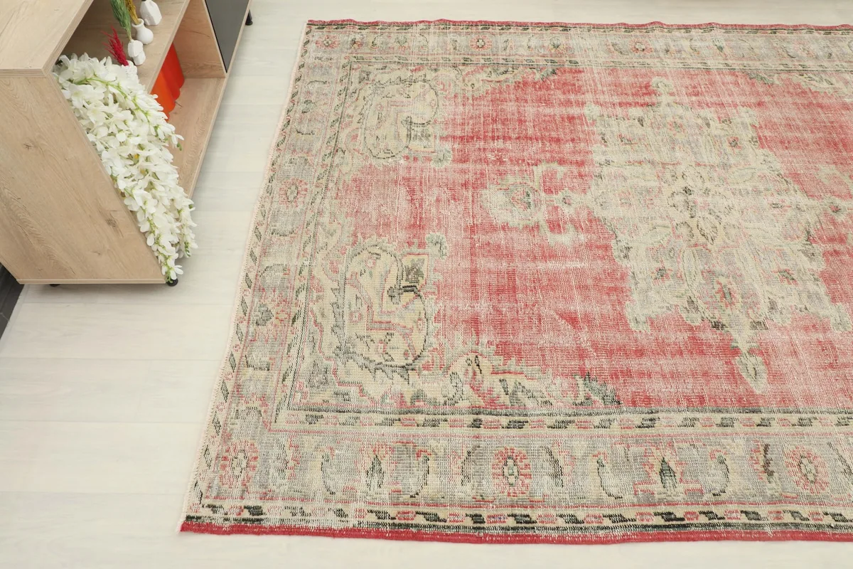 Detail view of the rug's patterns and colors from an elevated angle in a room setting