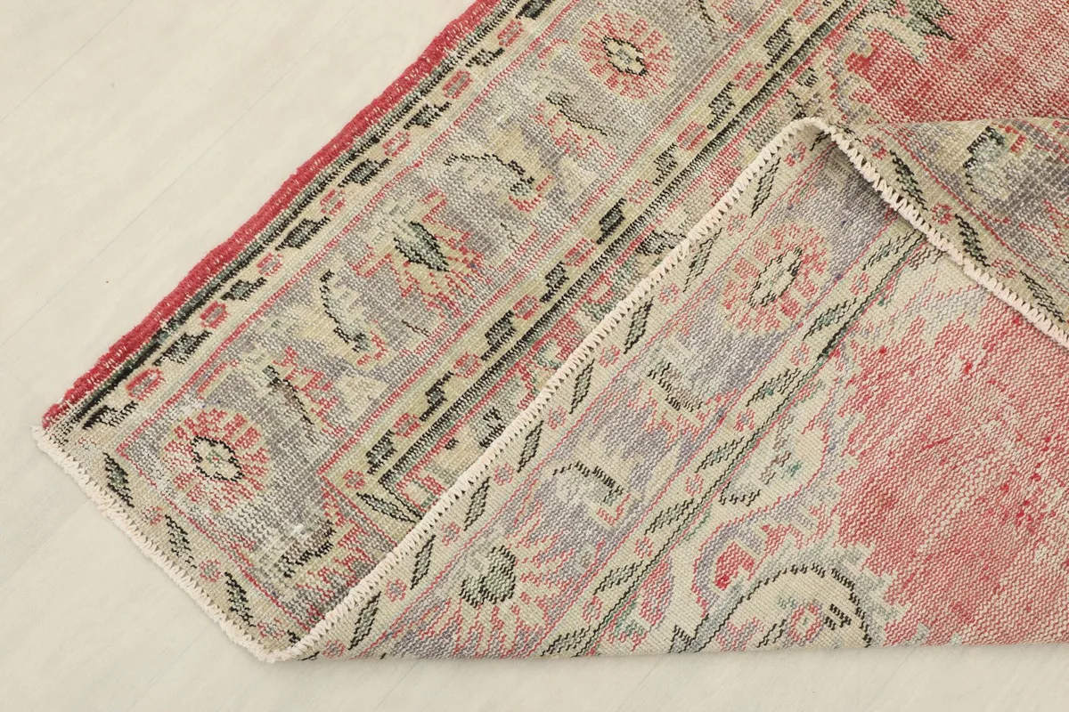 Corner of the rug folded back, showing the back and the front pile texture