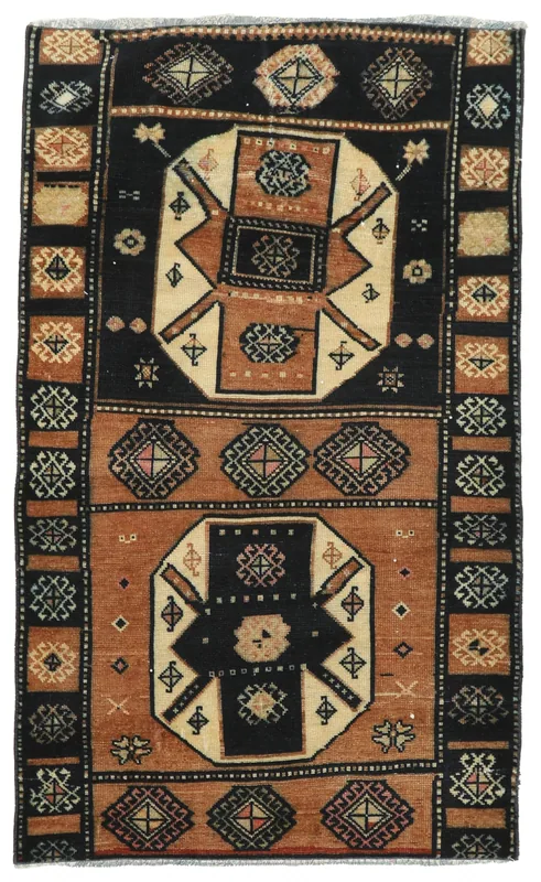 Full top view of the black and rust geometric vintage Anatolian rug on a white background.