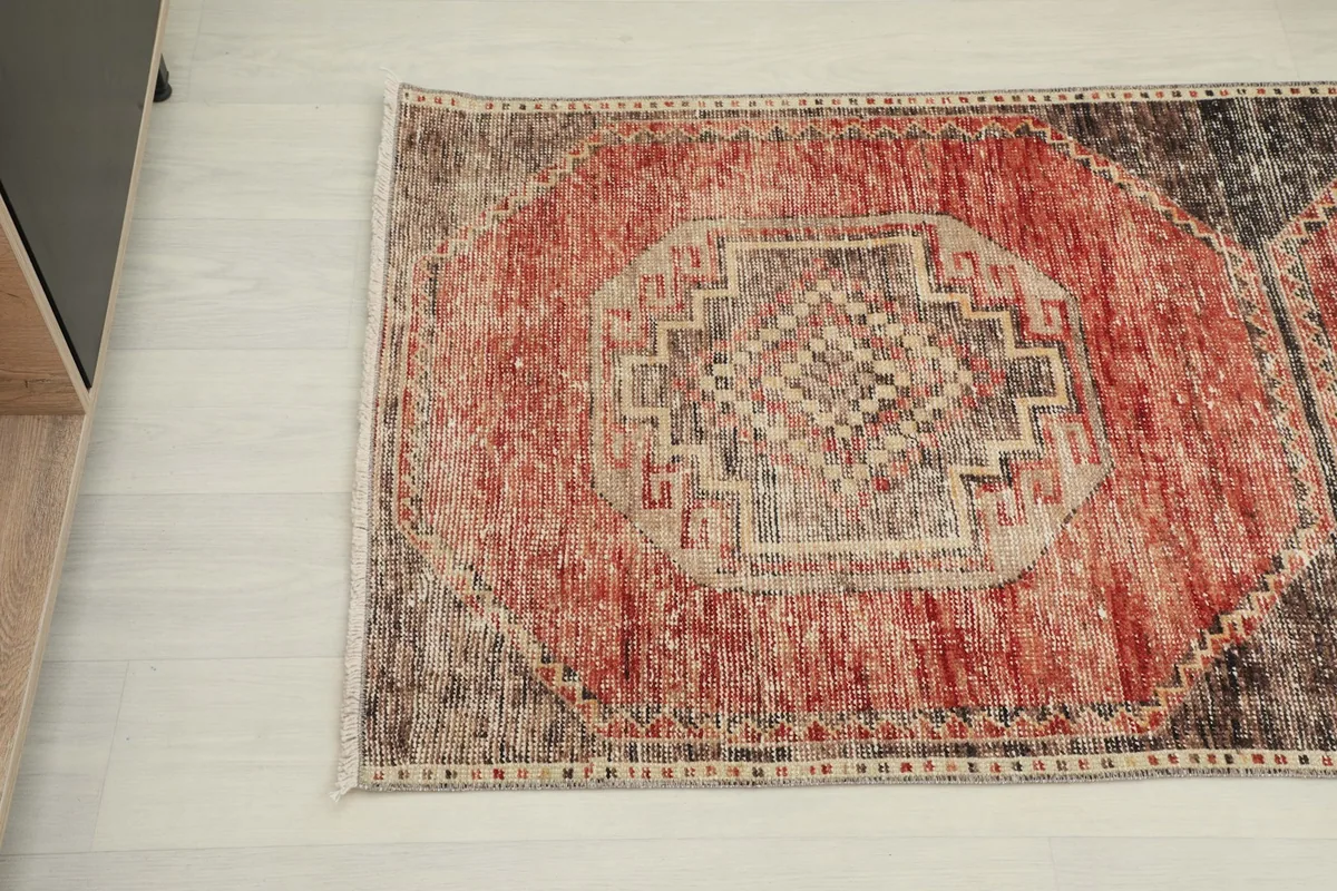 Overhead angle of the rug's middle section, showing the central medallion and color variations.