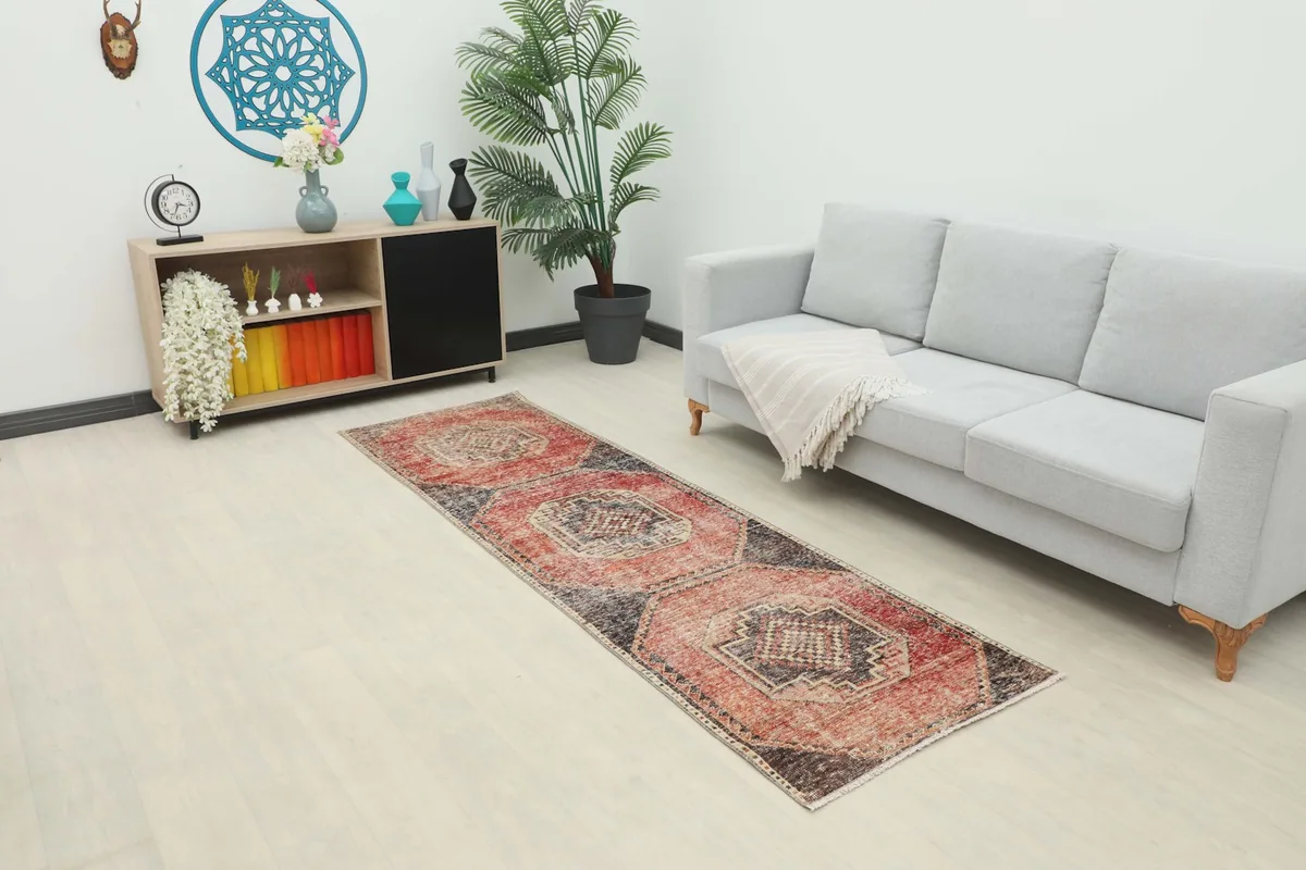 Runner rug displayed in a modern living space with a light gray sofa and wooden cabinet.