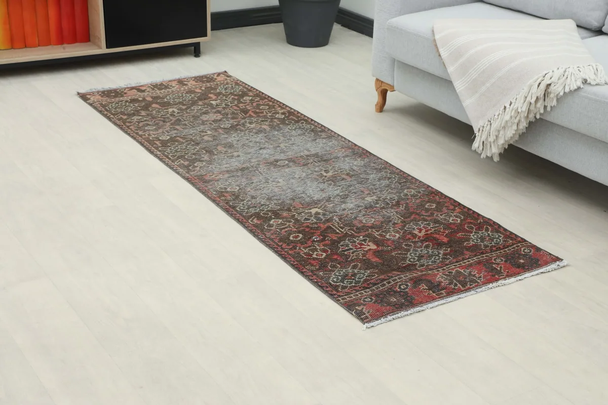 Overhead view of the charcoal and red runner rug placed in a contemporary room, highlighting its design.