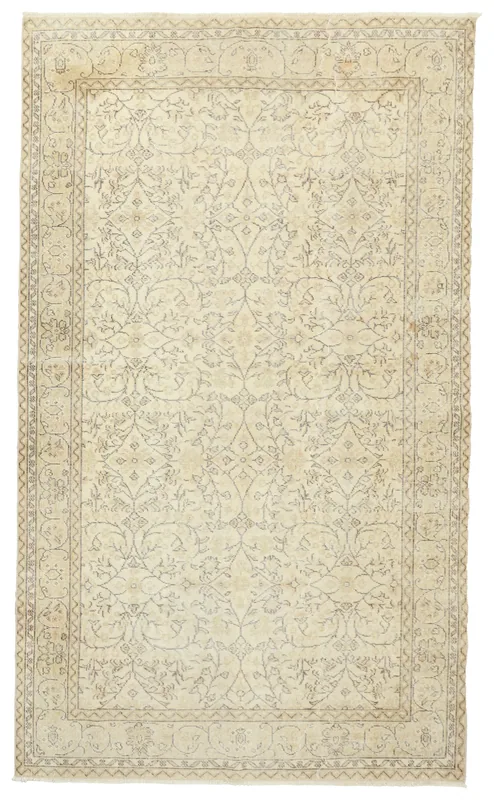 Full overhead view of the 5'9" x 9'8" ivory vintage Anatolian rug with subtle gray floral patterns.