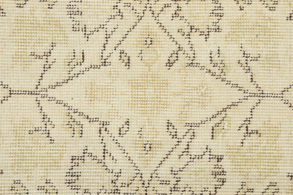 Close-up of the low wool pile, illustrating the hand-knotted texture and vintage wear.