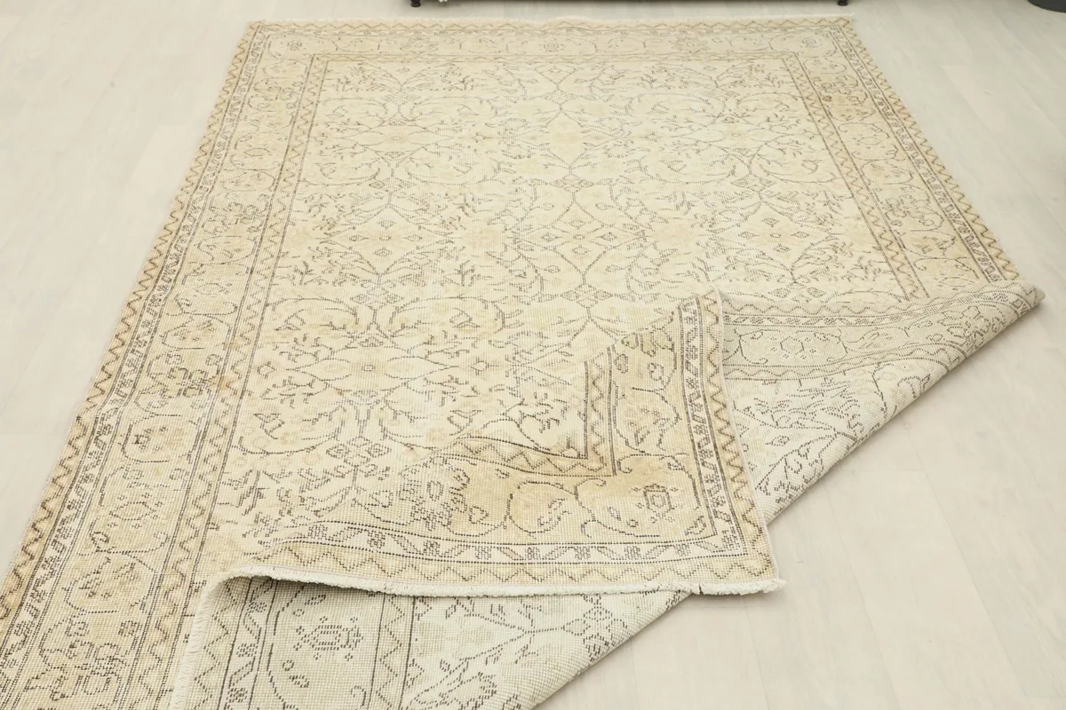 Partial view of the rug with a corner folded, indicating its flexibility and material.