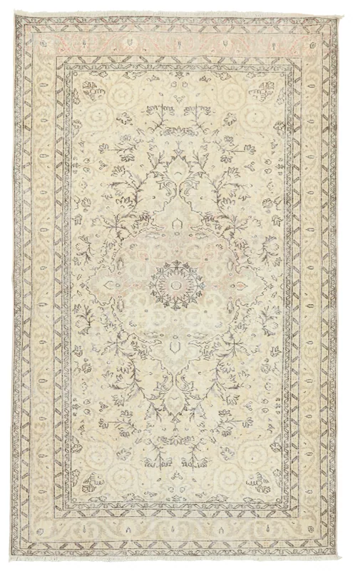 Full overhead view of the beige vintage Anatolian area rug with a central medallion.