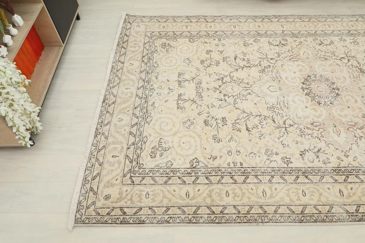 Overhead angled view of the rug, showing the intricate medallion and floral patterns.