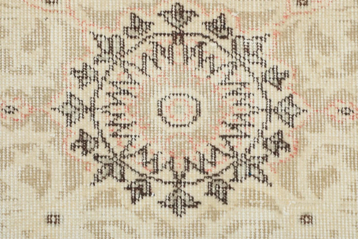 Extreme close-up of a section of the central medallion, showing individual knots and color variation.