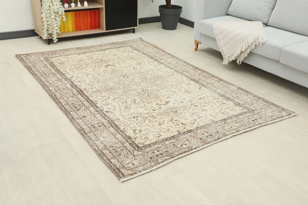 Angle view of the cream and gray rug in a living room, showing its size in context