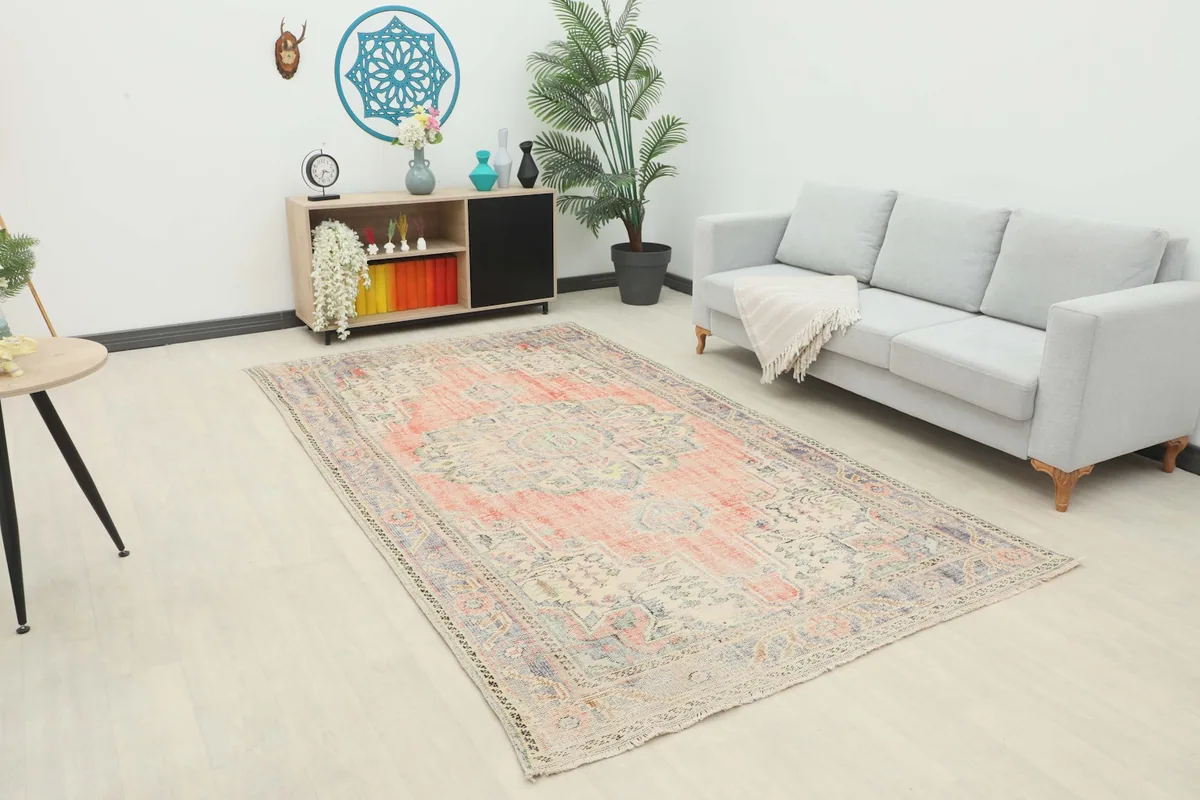 Vintage rust and blue area rug displayed in a modern living room setting
