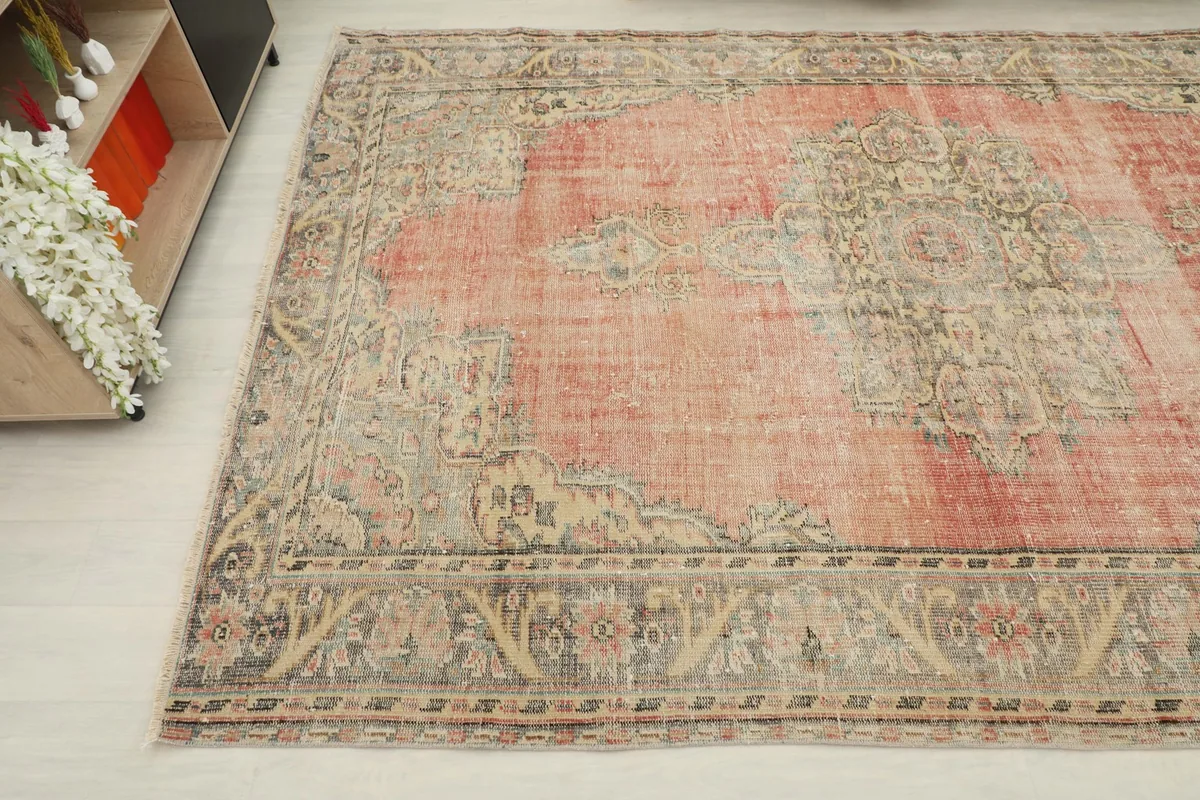 Another angle view highlighting the faded rust color and the detailed floral border