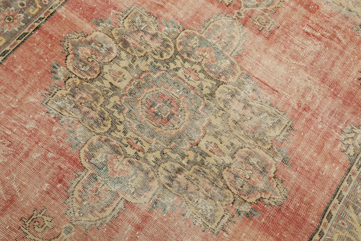 Detailed view of the central medallion design, showing muted colors and texture
