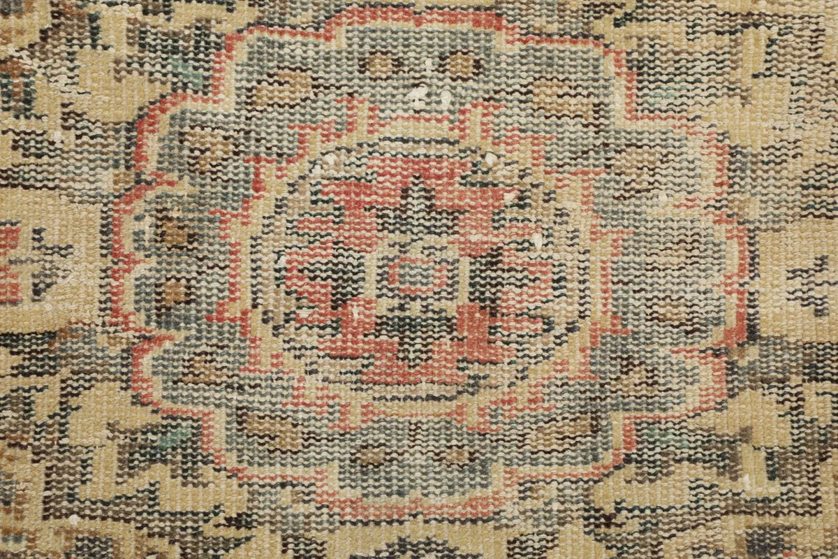 Close-up of the low wool pile and intricate weaving of the vintage rug