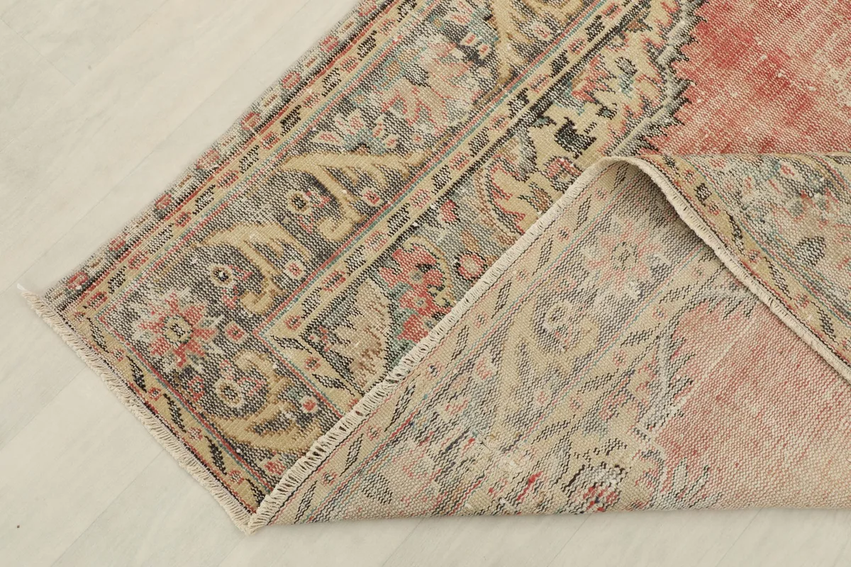 View of the rug's backside, revealing the hand-knotted construction and cotton foundation