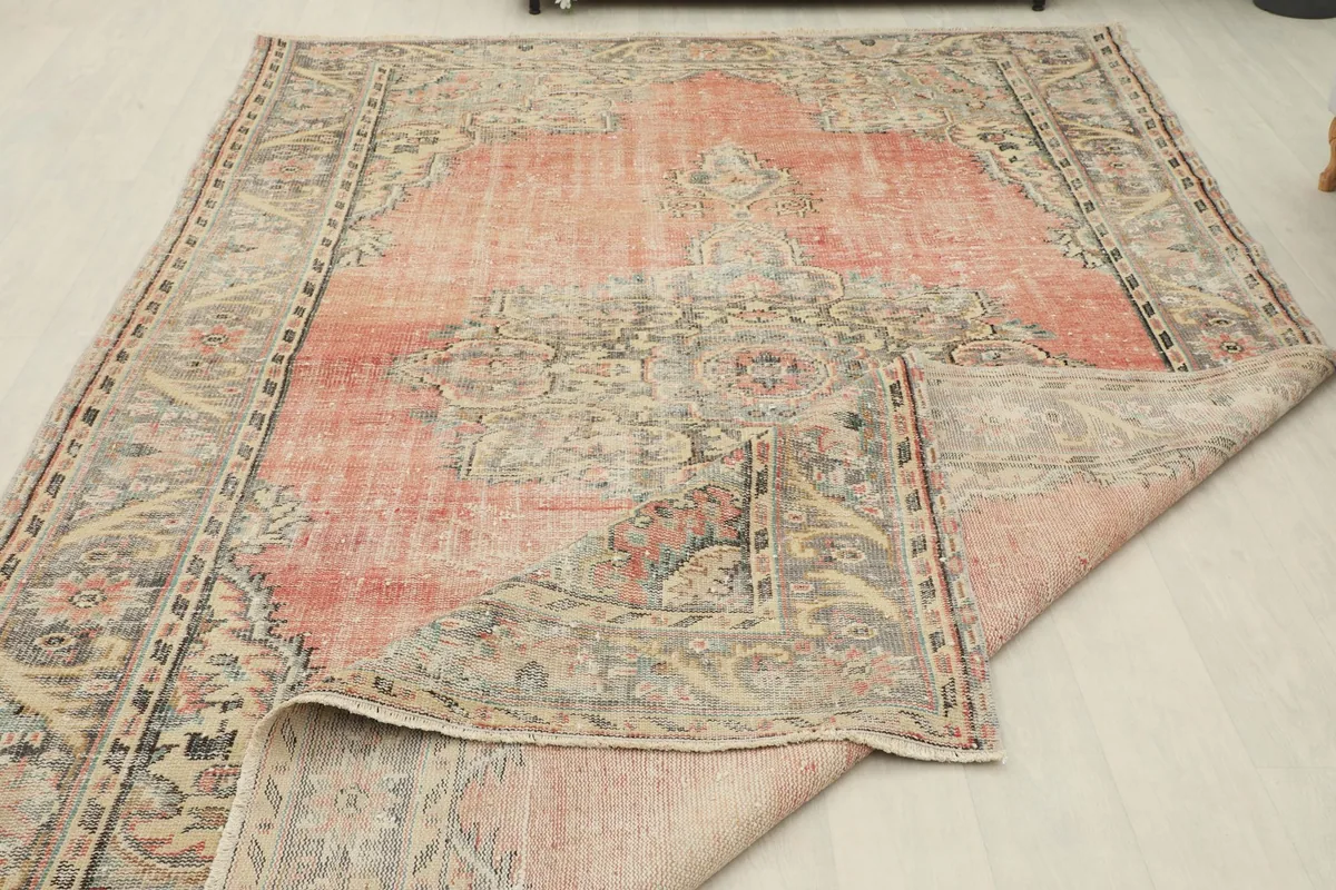 The rug partially folded to show the flexibility and thickness of the material