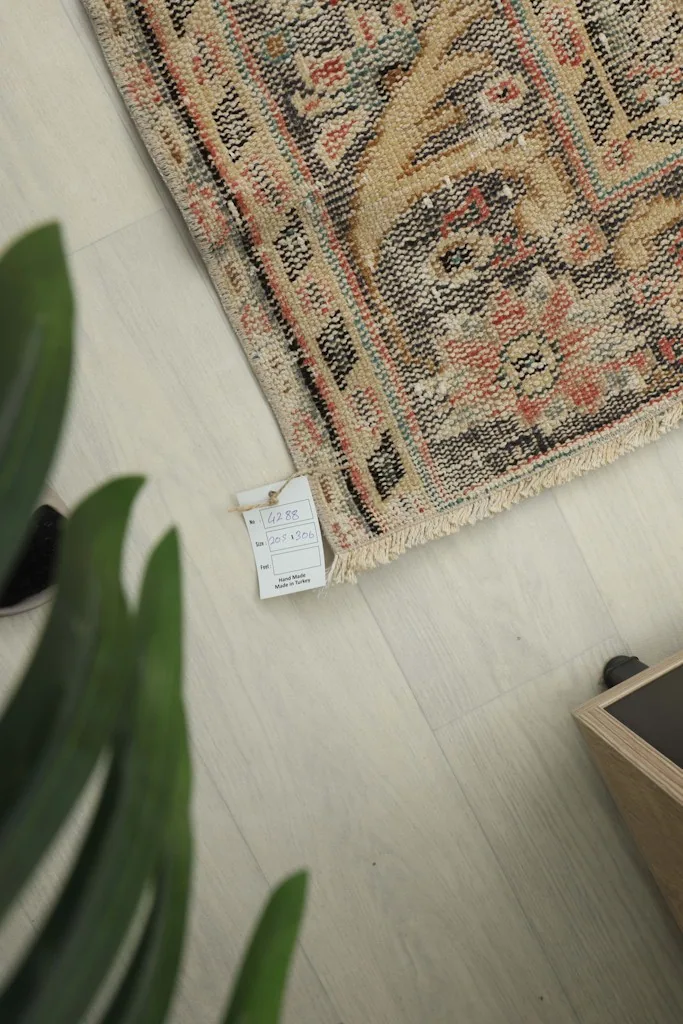 Close-up of the rug corner with a product tag, showing the natural fiber texture