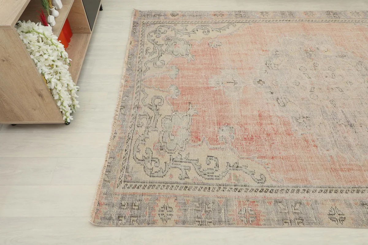 Angled perspective of the Anatolian rug, highlighting the soft rose and beige hues