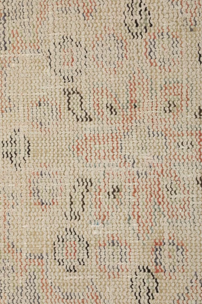 Detailed view of the low wool pile and hand-knotted texture of the rug