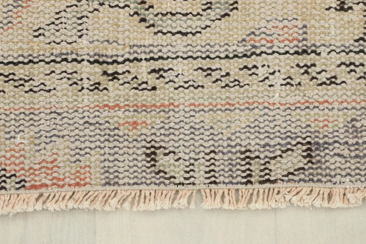Close-up of the natural cotton fringe and edge of the vintage Anatolian rug