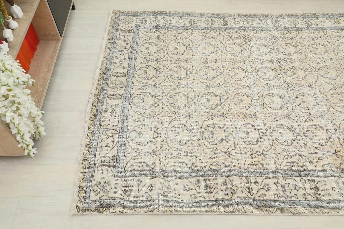 Overhead angle view of the vintage Anatolian rug, showing its texture and pattern details in a room setting.