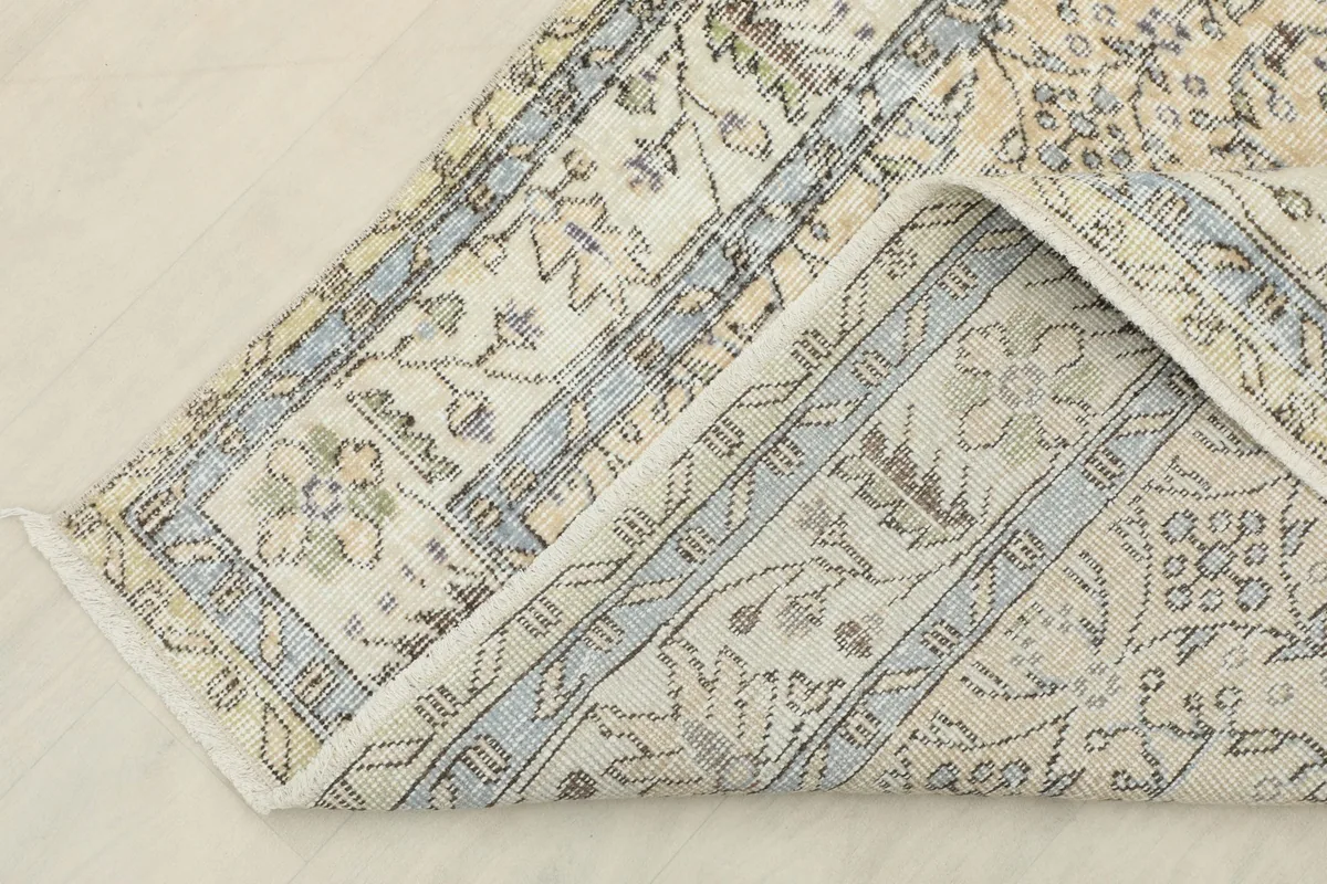 Underside view of the hand-knotted rug, showing the cotton foundation and construction.
