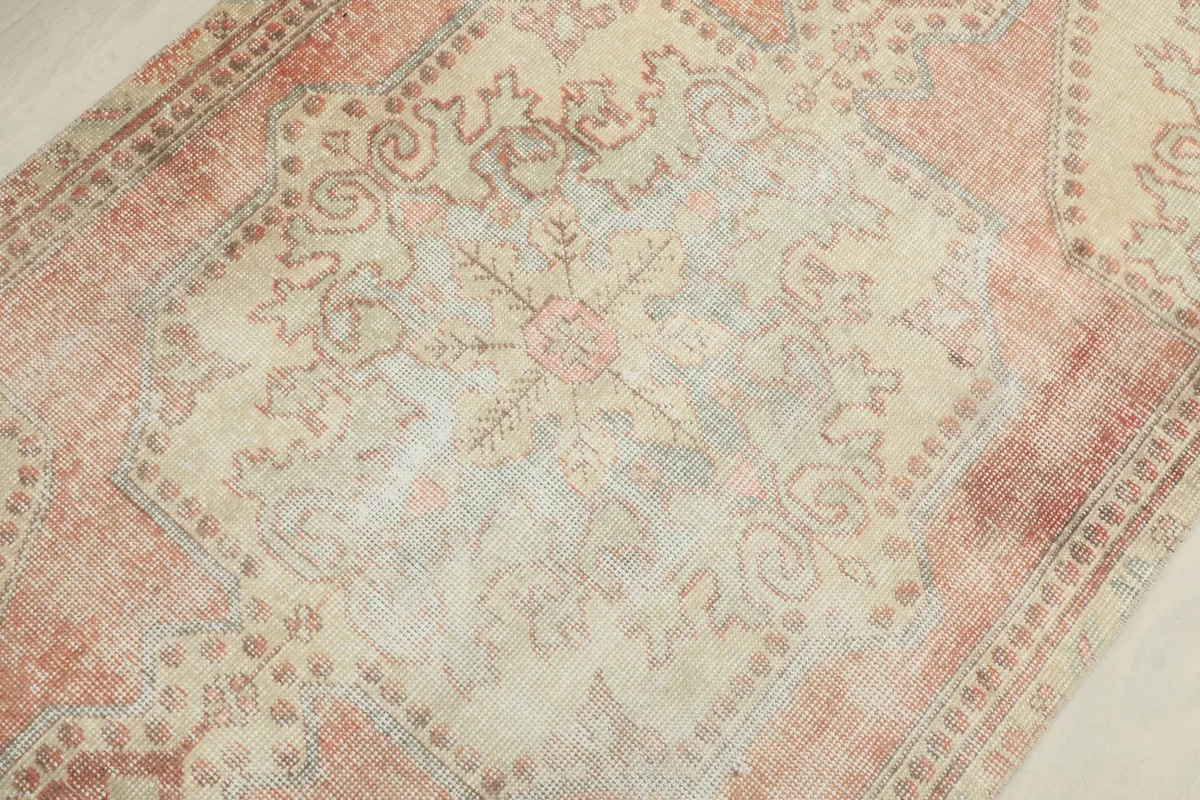 Close-up of the central medallion and surrounding patterns on the rug