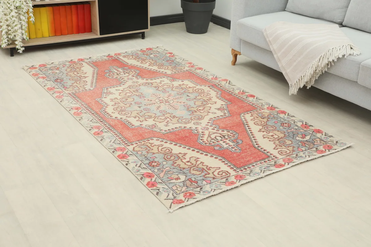 Rust Ivory Medallion Anatolian Rug from a slight angle in a modern room setting