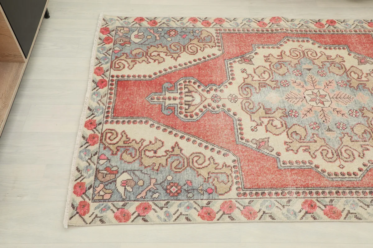 Rust Ivory Medallion Anatolian Rug showing the top left corner and floral border