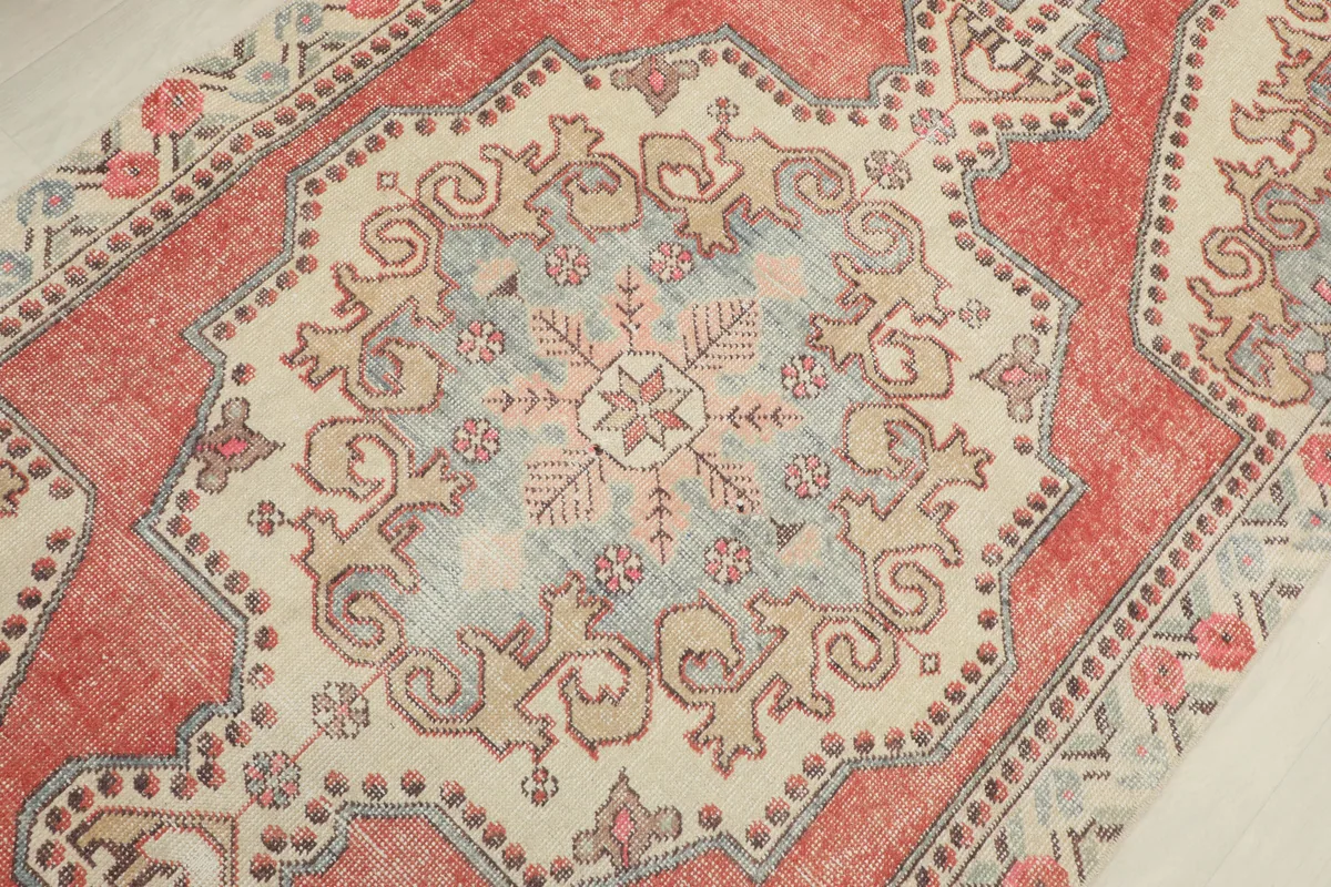 Rust Ivory Medallion Anatolian Rug close-up of the central ivory and blue medallion