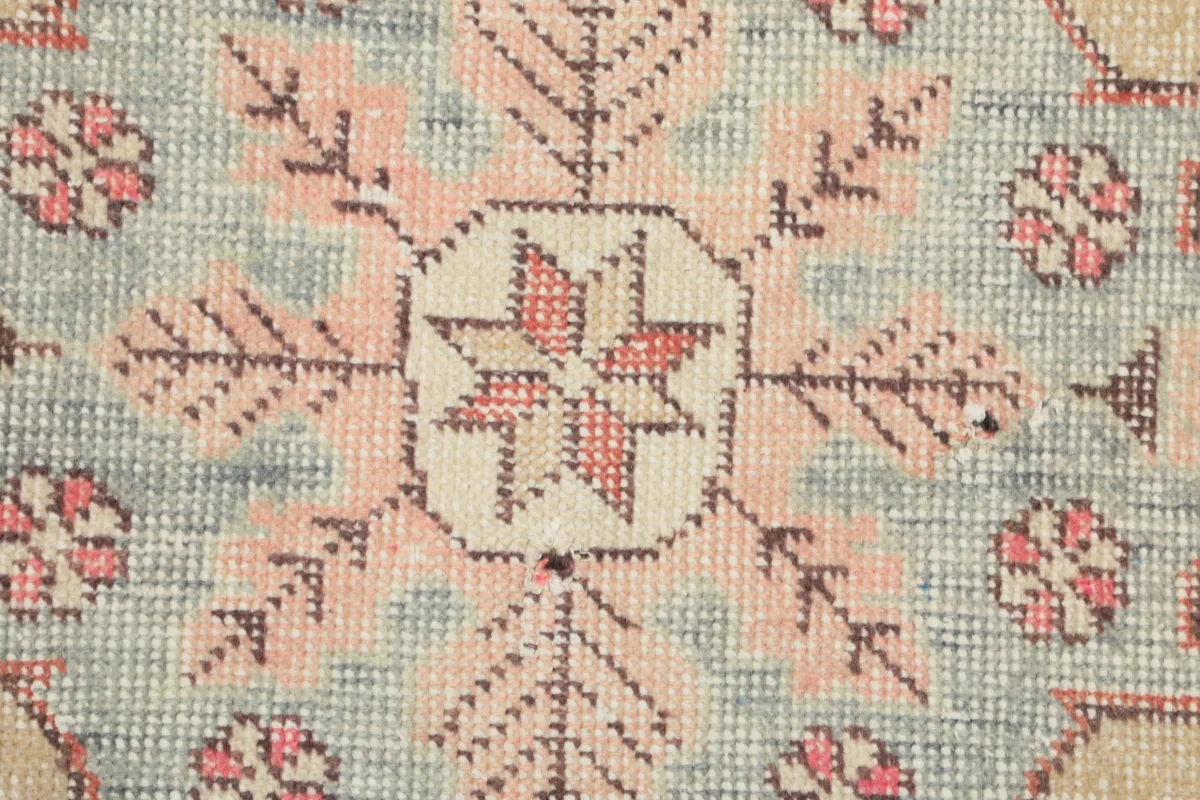 Rust Ivory Medallion Anatolian Rug extreme close-up of the central motif with rose and ivory tones