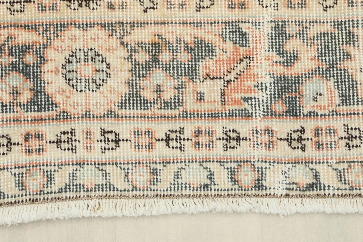 Detail of the rug's border and fringe, showing the intricate patterns and finish.