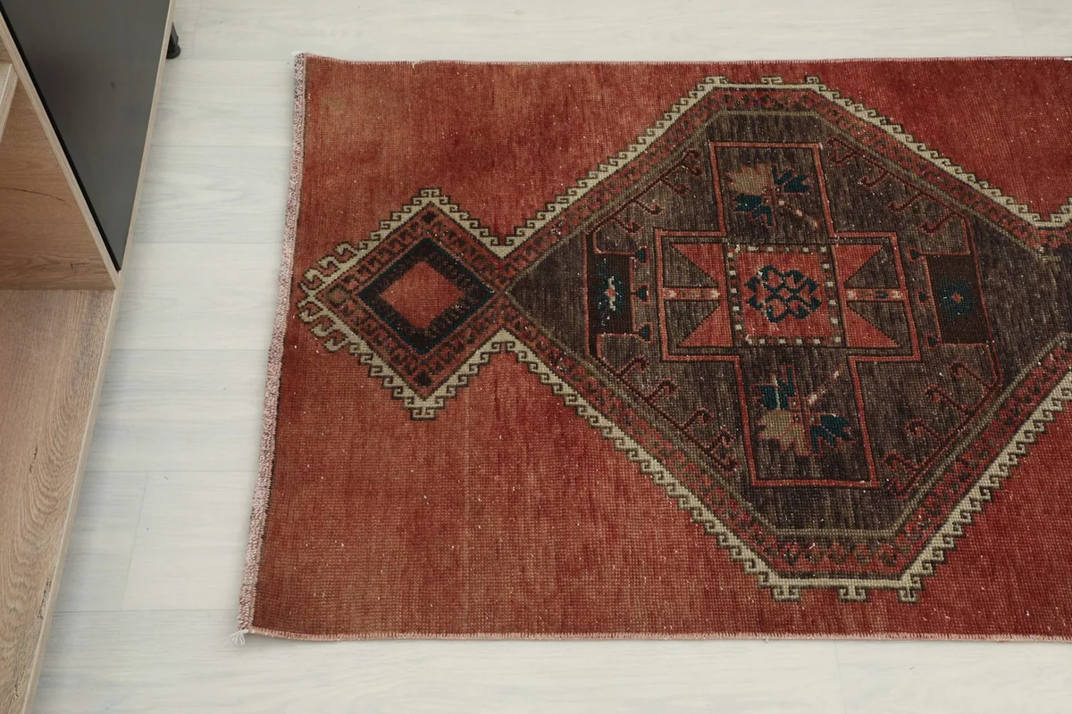 Overhead angled view of the runner rug's design, capturing the distinct tribal motifs