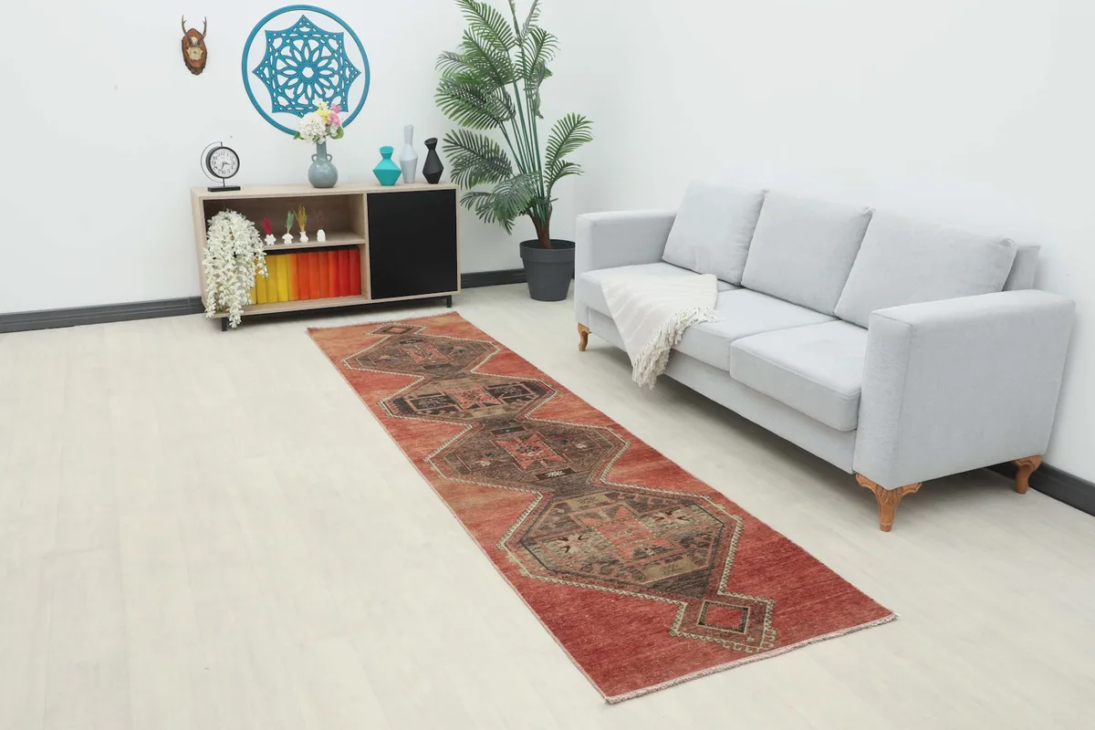 Runner rug displayed in a living room setting, showing its long length and design