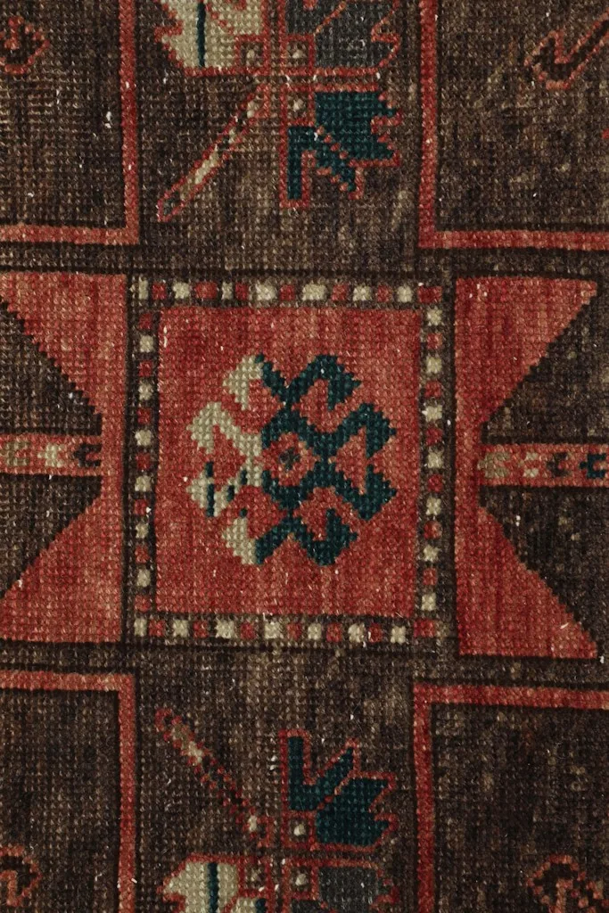 Extreme close-up of the intricate hand-knotted details within a medallion, showing fiber texture