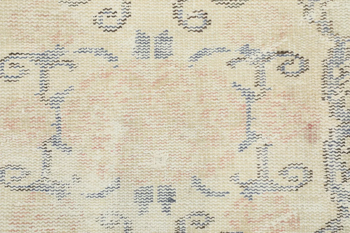 Close-up of the Faded Gray Rose Medallion Rug's low wool pile and hand-knotted texture.