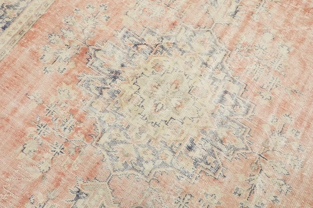 Detailed view of the central rust medallion and surrounding faded patterns