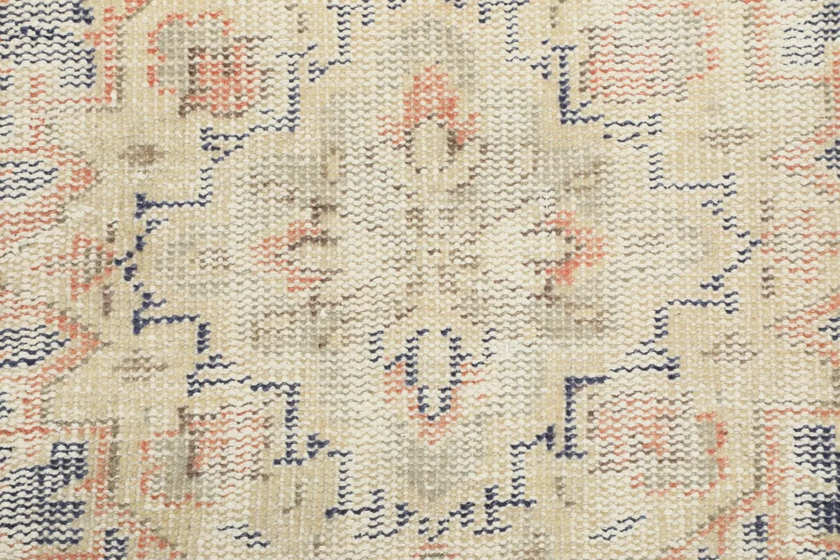 Close-up of the low wool pile and intricate geometric weaving on the rug