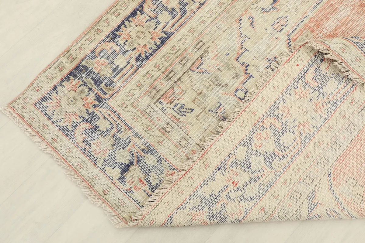 Underside of the rug, showing the cotton foundation and hand-knotted construction