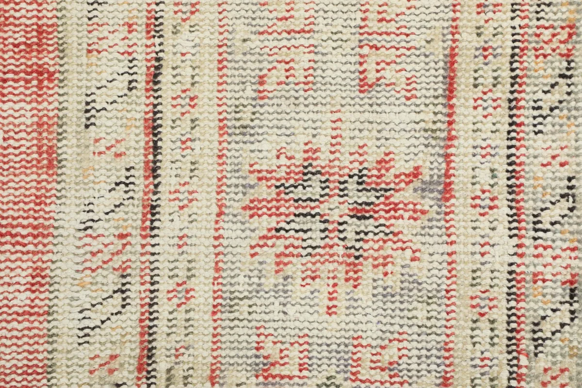 Detailed shot of the low wool pile, revealing the hand-knotted texture and color variations