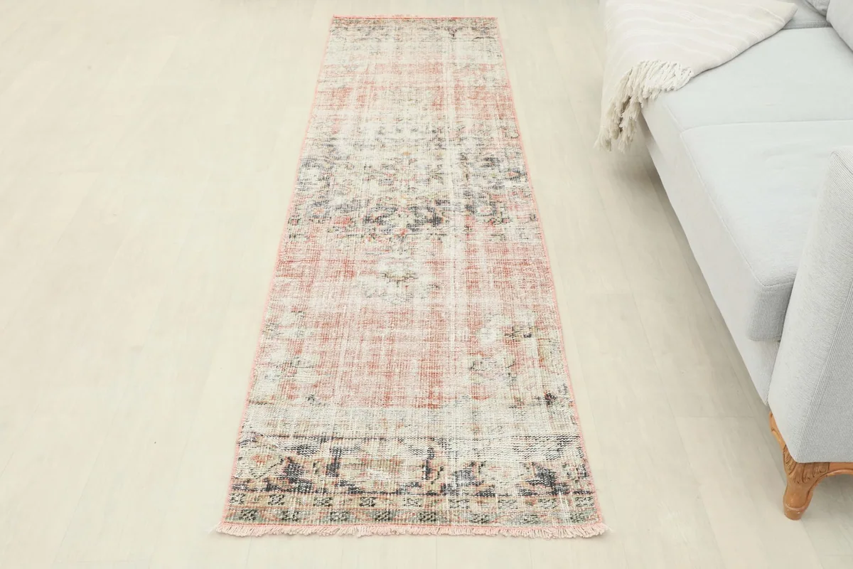 Full view of the vintage runner rug placed in a room, offering a sense of scale and color