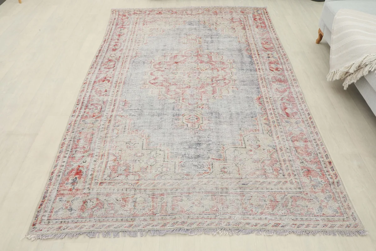Overhead view of the entire rose and gray vintage rug in a room setting