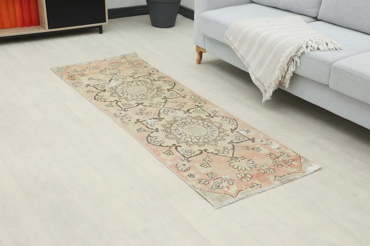 Angled view of the runner rug placed in a room, highlighting its length and pattern.