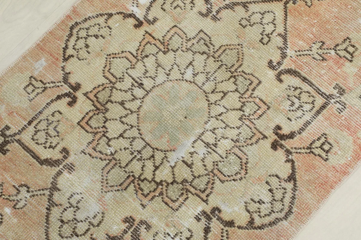 Detailed view of a central medallion motif, showcasing the intricate hand-knotting.