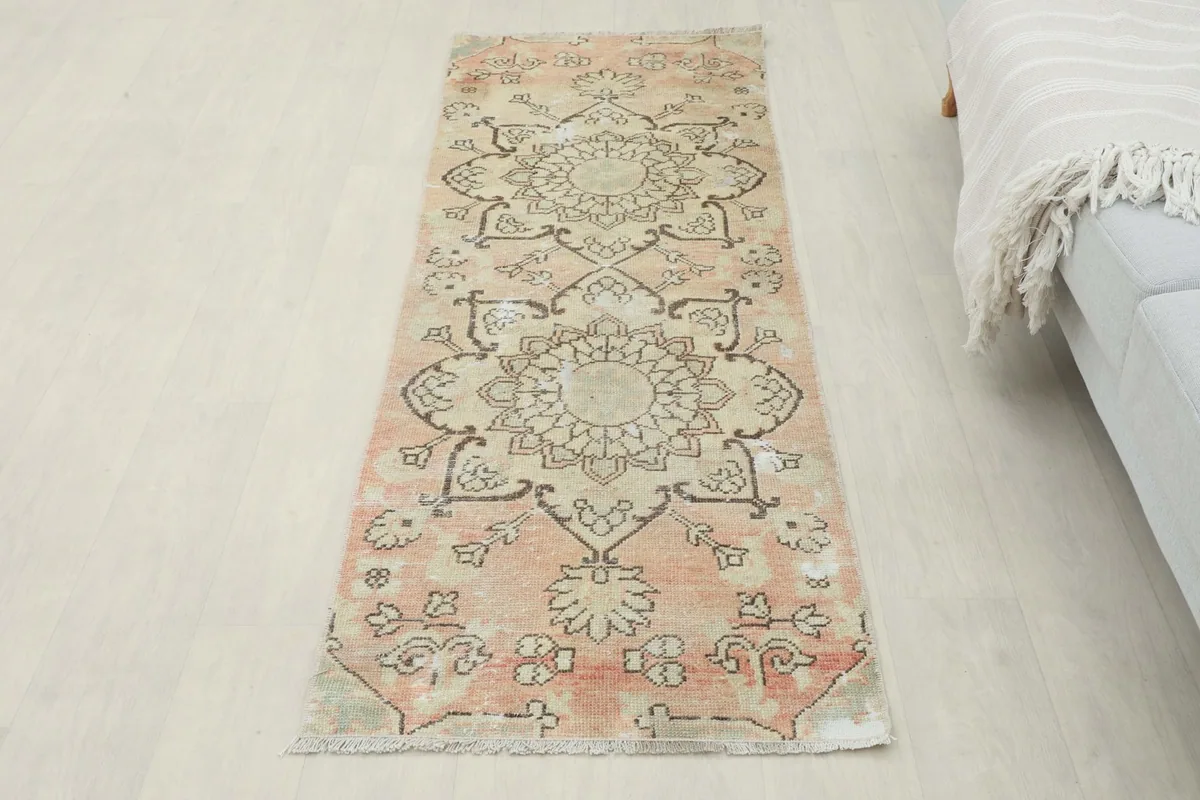 Full overhead view of the vintage Anatolian runner rug in a room, showing its overall design.