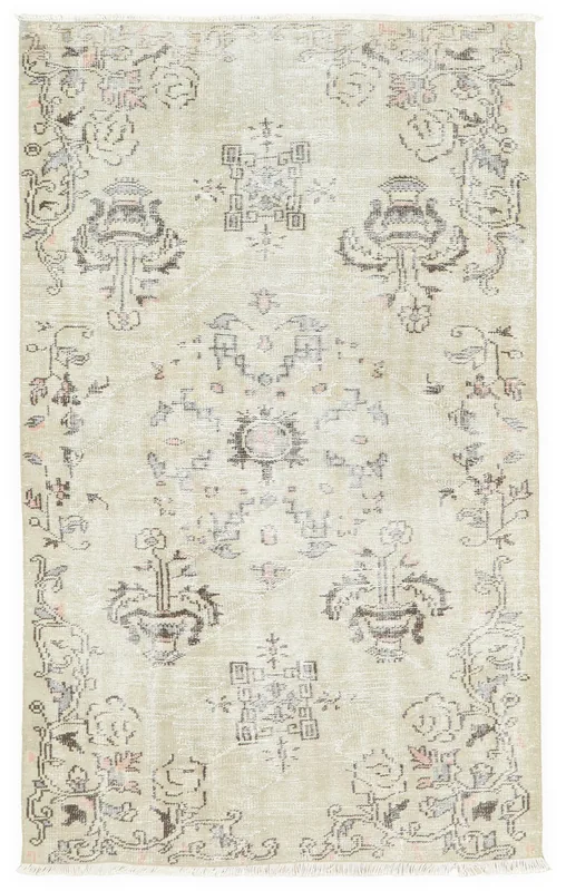 Full overhead view of the beige vintage Anatolian rug with floral and geometric patterns