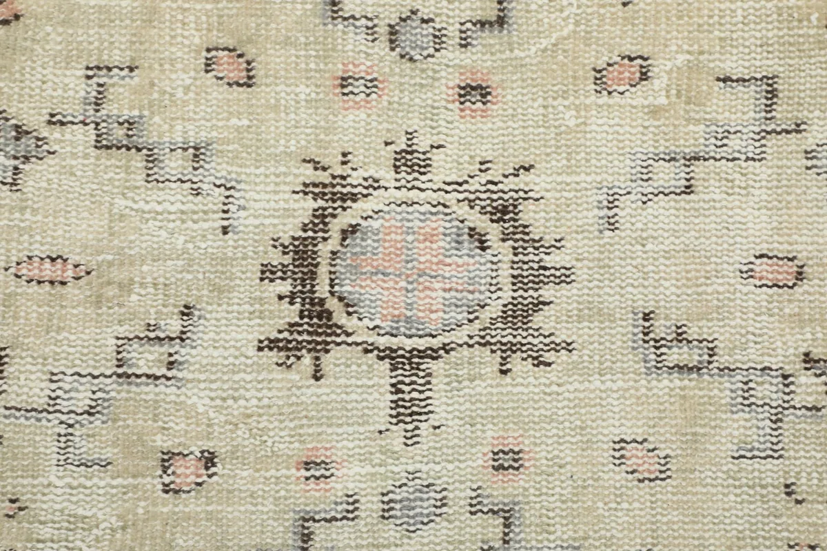 Close-up of the rug's central design, showcasing the texture and color variations of the wool pile