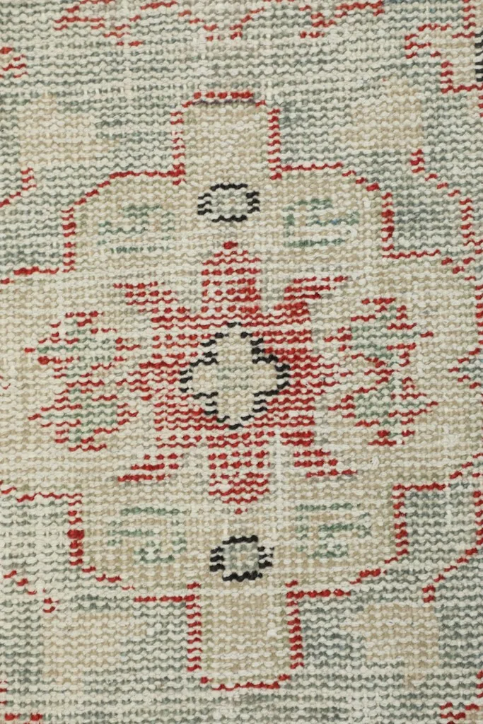 Extreme close-up of the wool pile and hand-knotted texture, showing individual knots