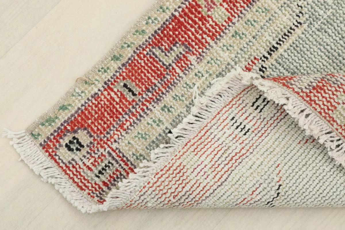 View of the back of the rug, showing the cotton foundation and tight hand-knotting