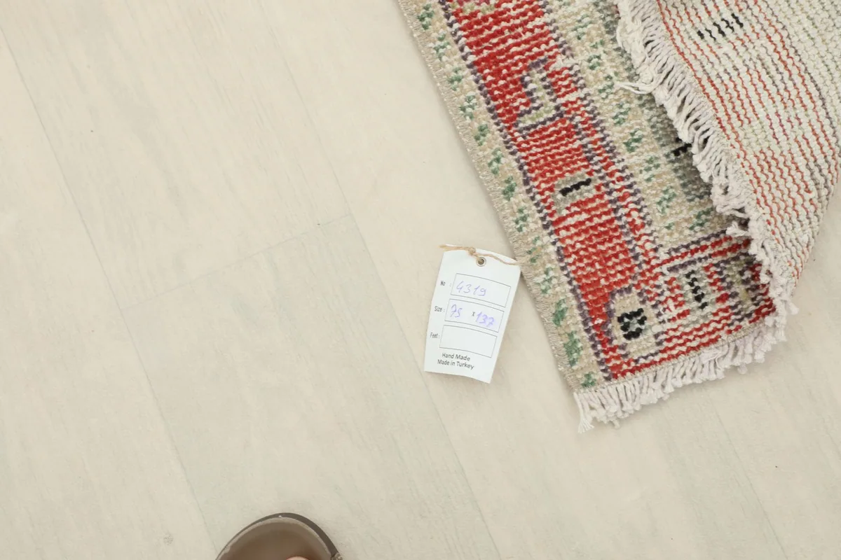 Close-up of the rug's label with product information and a corner of the rug